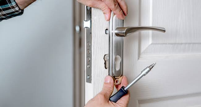 Locksmith repairing a multipoint lock
